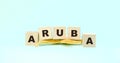 Word Aruba made with wooden cubes and starfish on mint green Royalty Free Stock Photo