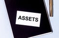 Word Assets on paper on office table. Financial accounting. Money concept Royalty Free Stock Photo