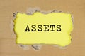 Word Assets on torn yellow paper. Financial accounting. Money concept Royalty Free Stock Photo