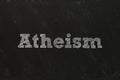 Word Atheism written on black chalkboard. Philosophical or religious position