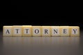 The word ATTORNEY written on wooden cubes isolated on a black background Royalty Free Stock Photo