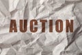 Word Auction on crumpled sheet of paper, closeup view Royalty Free Stock Photo