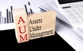 Word AUM made with wood building blocks, business concept Royalty Free Stock Photo