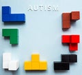 The word AUTISM on a blue background, with various colored blue cubes. World autism awareness day concept. Royalty Free Stock Photo