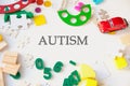 Word autism and educational toys on light background, world autism awareness day concept, development of children with autism Royalty Free Stock Photo