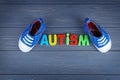 Word AUTISM with kids shoes