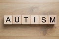 Word Autism made of cubes on wooden background, top view Royalty Free Stock Photo