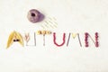 Word autumn written with leaves, apples, berries, tree sticks, n