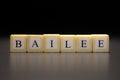 The word BAILEE written on wooden cubes isolated on a black background Royalty Free Stock Photo