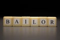 The word BAILOR written on wooden cubes isolated on a black background Royalty Free Stock Photo