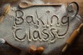 The word baking class written on sprinkled flour