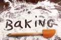 Word baking written in white flour on wooden table