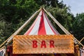 Word BAR at wooden signboard with light bulbs. Vintage sign. Vintage exterior design of bar or pub at food and drink festival. Bar Royalty Free Stock Photo