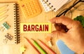 The word BARGAIN made from wooden cubes on blue background. Conceptual photo Royalty Free Stock Photo