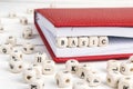 Word Basic written in wooden blocks in notebook on wooden table.