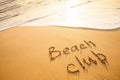 The word Beach club written in the sand on the beach