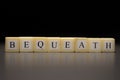 The word BEQUEATH written on wooden cubes isolated on a black background