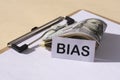 The word Bias and and 100 dollar bills. Prejudice. Personal opinions