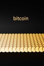 The word Bitcoin near a large number of bitcoin coins