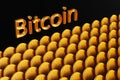 The word Bitcoin near a large number of bitcoin coins