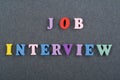 JOP INTERVIEW word on black board background composed from colorful abc alphabet block wooden letters, copy space for ad text.