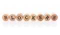 Word Blockers from circular wooden tiles with letters children toy. Concept of hormones, puberta or adds spelled in children toy Royalty Free Stock Photo