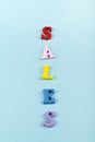 Sales word on blue background composed from colorful abc alphabet block wooden letters, copy space for ad text. Learning english Royalty Free Stock Photo