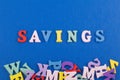 SAVINGS word on blue background composed from colorful abc alphabet block wooden letters, copy space for ad text. Learning english Royalty Free Stock Photo