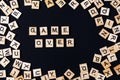 Word BOARD GAME with wooden letters on black board and letter in the circle