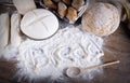 Word 'bread' written on flour scattered on wooden table