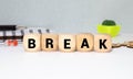 Word break. Top view of wooden blocks with letters on yellow surface Royalty Free Stock Photo