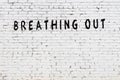 Word breathing out painted on white brick wall Royalty Free Stock Photo