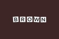 The word BROWN ,spelt with letter Scrabble tiles on a brown background