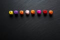 Word Business from colorful wooden cubes on black slate stone background. Free space for your text Royalty Free Stock Photo