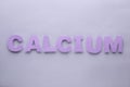 Word Calcium made of purple letters on light grey background, flat lay Royalty Free Stock Photo