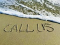 Word call us in the sand Royalty Free Stock Photo