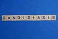 Word candidiasis made from wooden gray letters