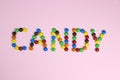 The word candy are contained by colored candies on a pink background Royalty Free Stock Photo