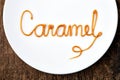Word Caramel on white plate Royalty Free Stock Photo