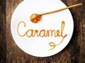 Word Caramel on white plate Royalty Free Stock Photo