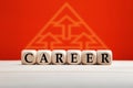 The word career on wooden blocks with hierarchy triangle background. Career development, plan, promotion or growth concept Royalty Free Stock Photo