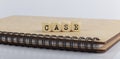 Word CASE made with letters on wooden blocks on wooden notepad