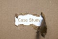 The word case study appearing behind torn paper.