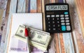 The word Cash flow on a calculator additionally close-up with dollars and euros, a notepad Royalty Free Stock Photo