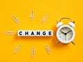 The word change on cubes with alarm clock and paper clips. Time for change Royalty Free Stock Photo