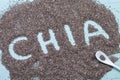 Word chia from chia seeds on blue background. Selective focus Royalty Free Stock Photo