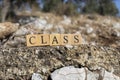 The word class was created from wooden cubes. Photographed on the wall.