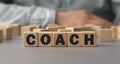 The word COACH made from wooden cubes. Shallow depth of field on the cubes Royalty Free Stock Photo