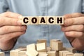 The word COACH made from wooden cubes. Shallow depth of field on the cubes Royalty Free Stock Photo