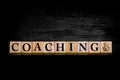 Word COACHING isolated on black background